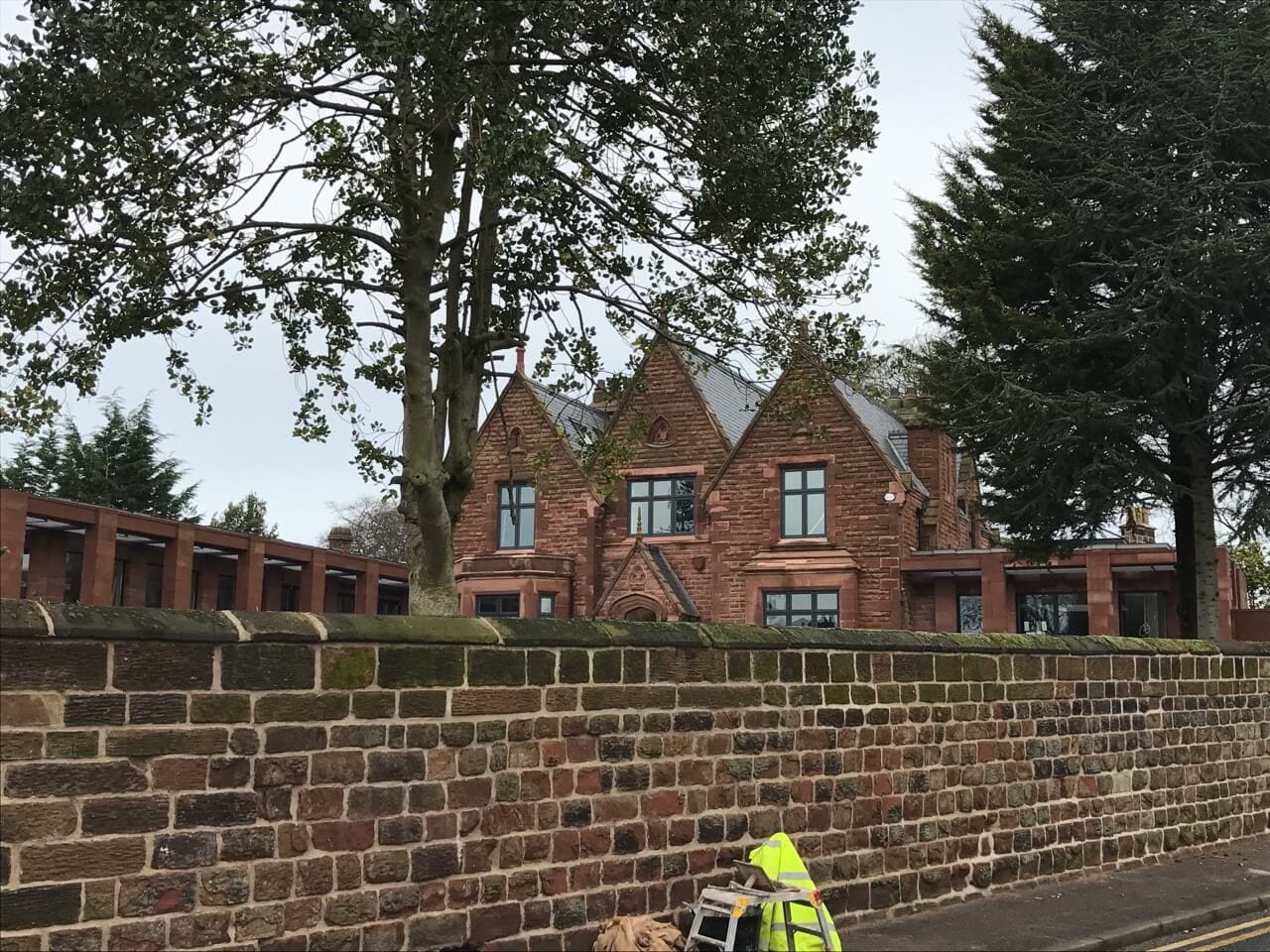 Lyons Stonework wallers expertly crafting stone walls for residential and heritage projects using traditional techniques.
